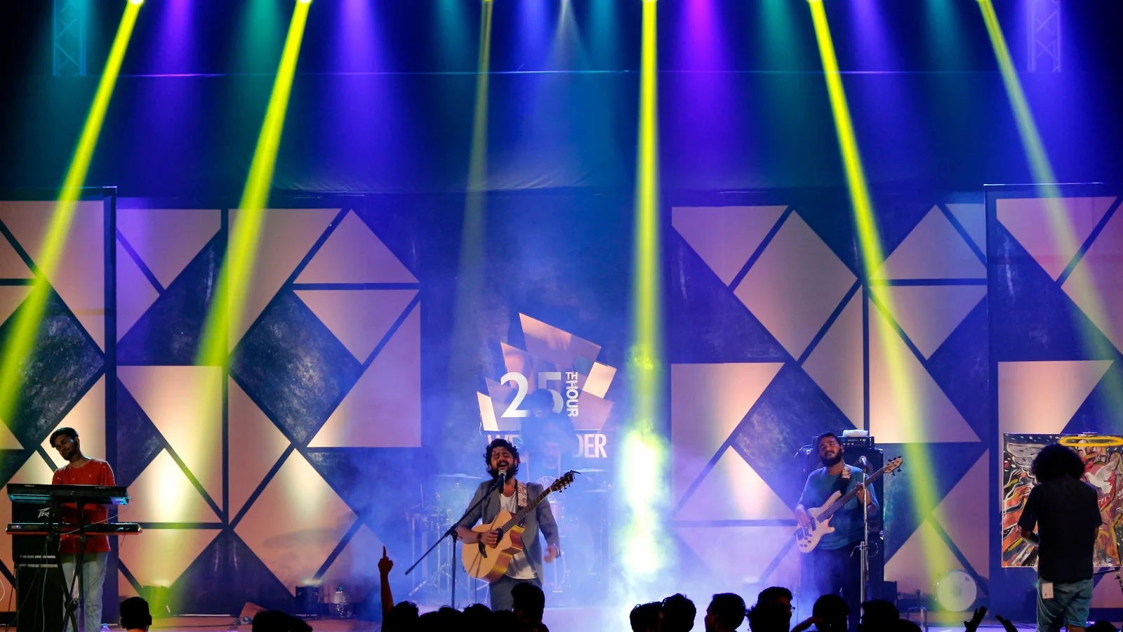 Worship band leading from a colorful church stage